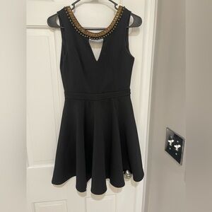 Beautiful black dress with gold details.